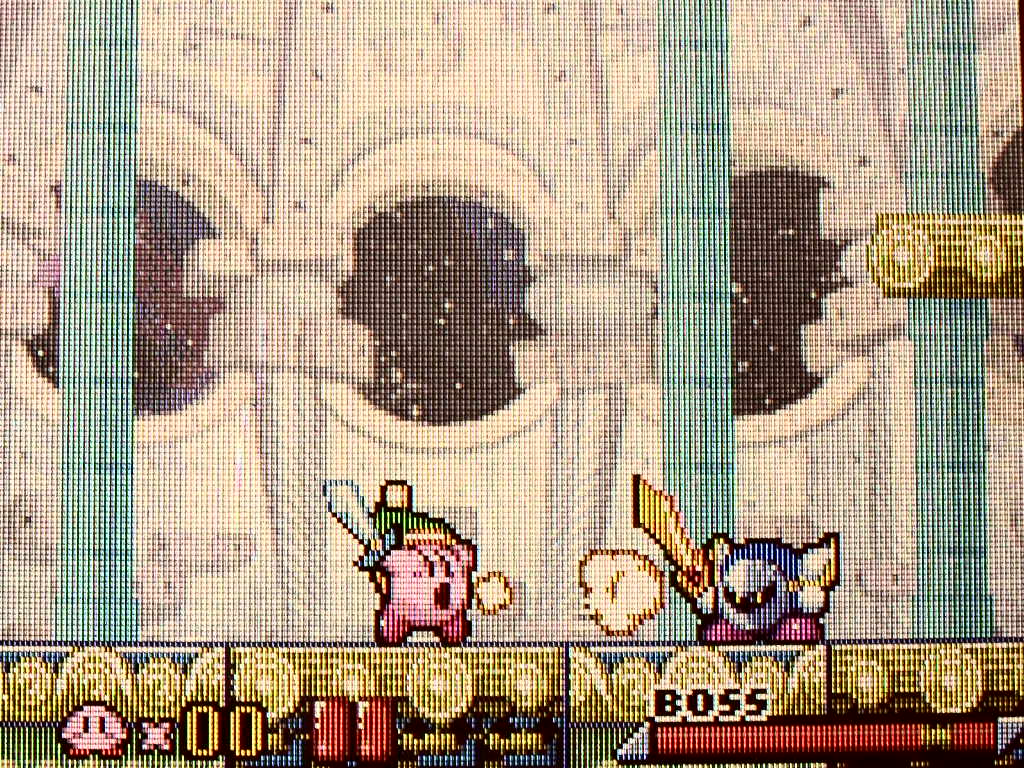 Kirby has damaged Meta Knight's health meter, leaving it with a transparent gap.