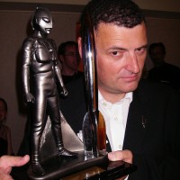 Stephen Moffat with his 2007 Hugo Award. - Moffat-hugo-girl-fireplace-200x200